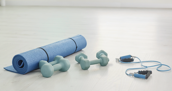 Illustrative photograph of resistance bands, small weights and a training mat