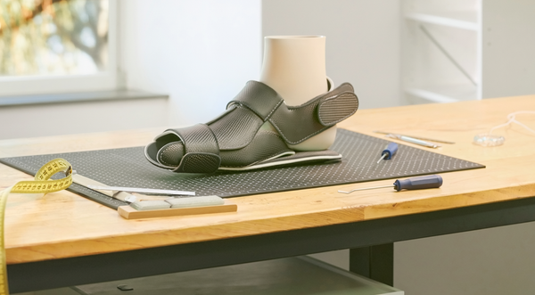 Illustrative photograph of customised foot support on an orthotics workbench