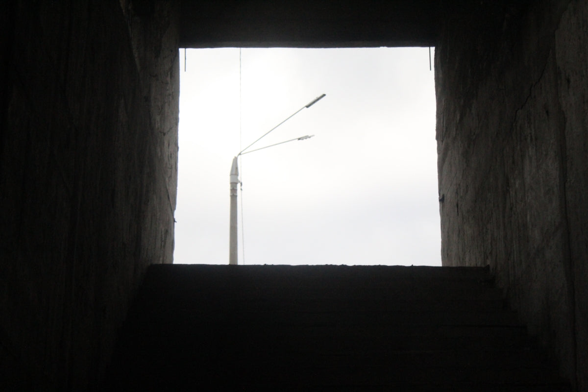 white metal rod on brown wooden wall