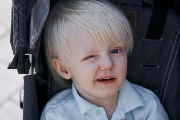 a little boy that is sitting in a stroller