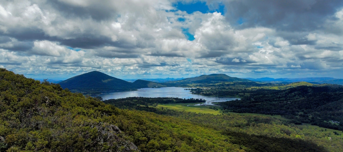 a scenic view of a lake surrounded by mountains