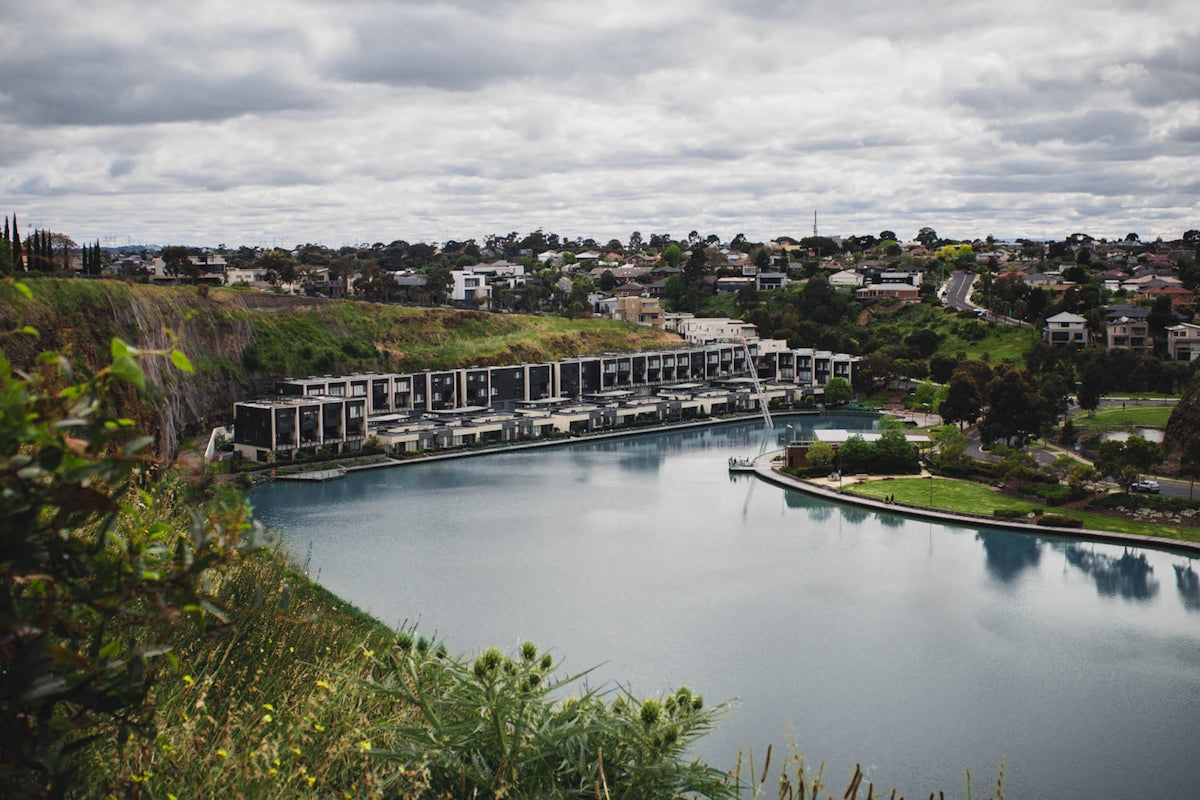 a body of water with buildings and trees around it