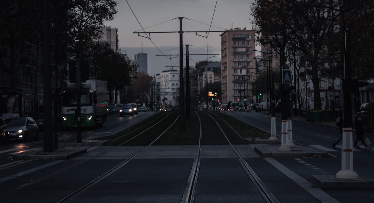 a city street with a train track running through it