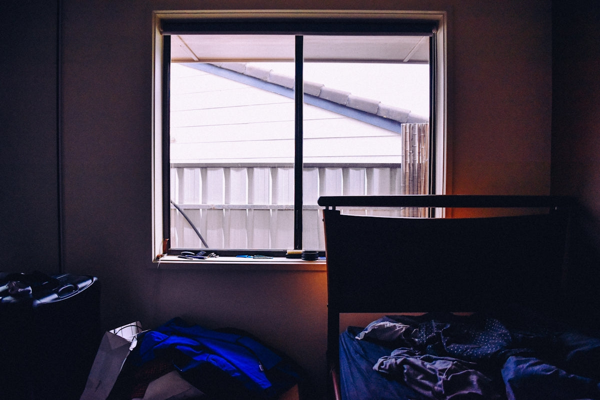 a bedroom with a bed and a window