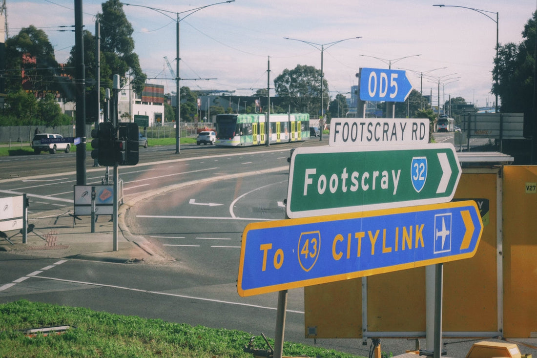a couple of street signs sitting on the side of a road
