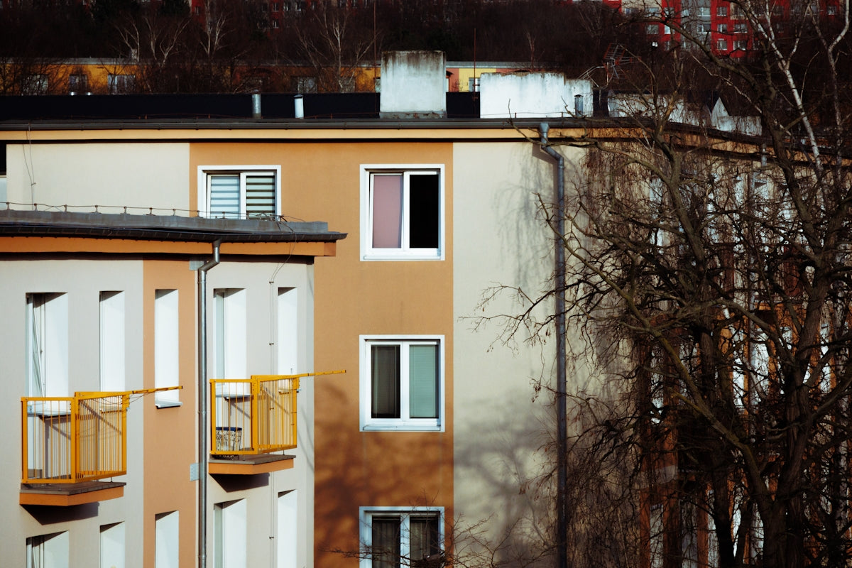 an apartment building with balconies and yellow balconies