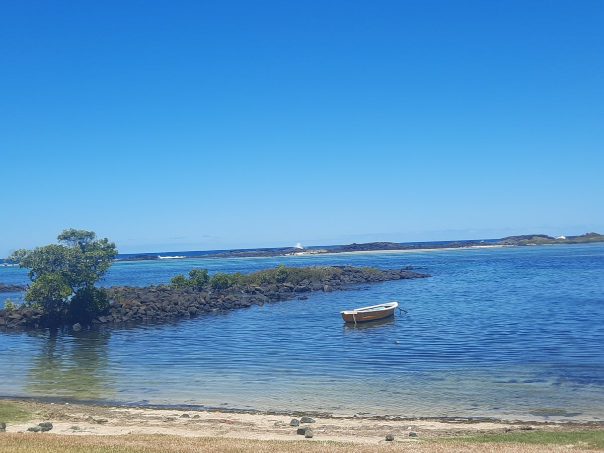 a small boat floating on top of a body of water
