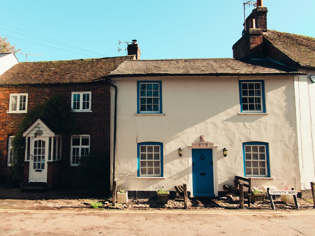 a white house with a blue door and windows