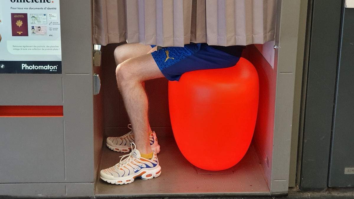 A person sitting on a large orange object