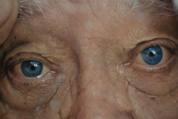 Close-up of an elderly person's blue eyes.