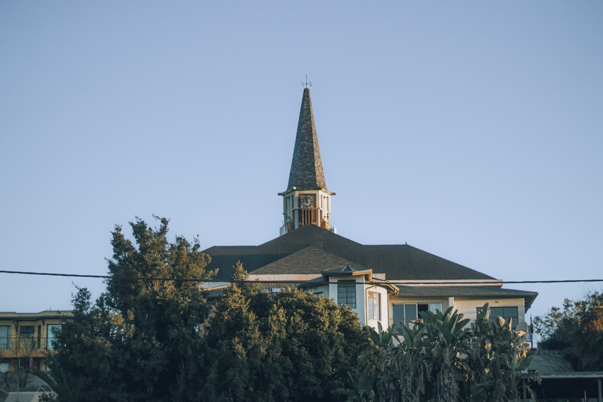 A church with a tall steeple in the sky.