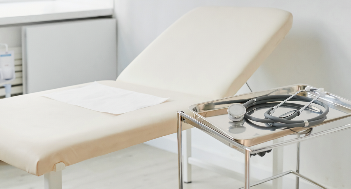 Illustrative photograph of an examination couch and clinical instrument tray