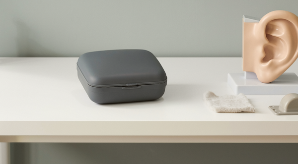 Illustrative photograph of a hearing-aid case and ear model