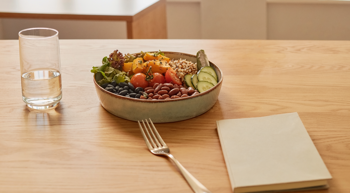 Illustrative photograph of a balanced meal and nutrition-planning notebook