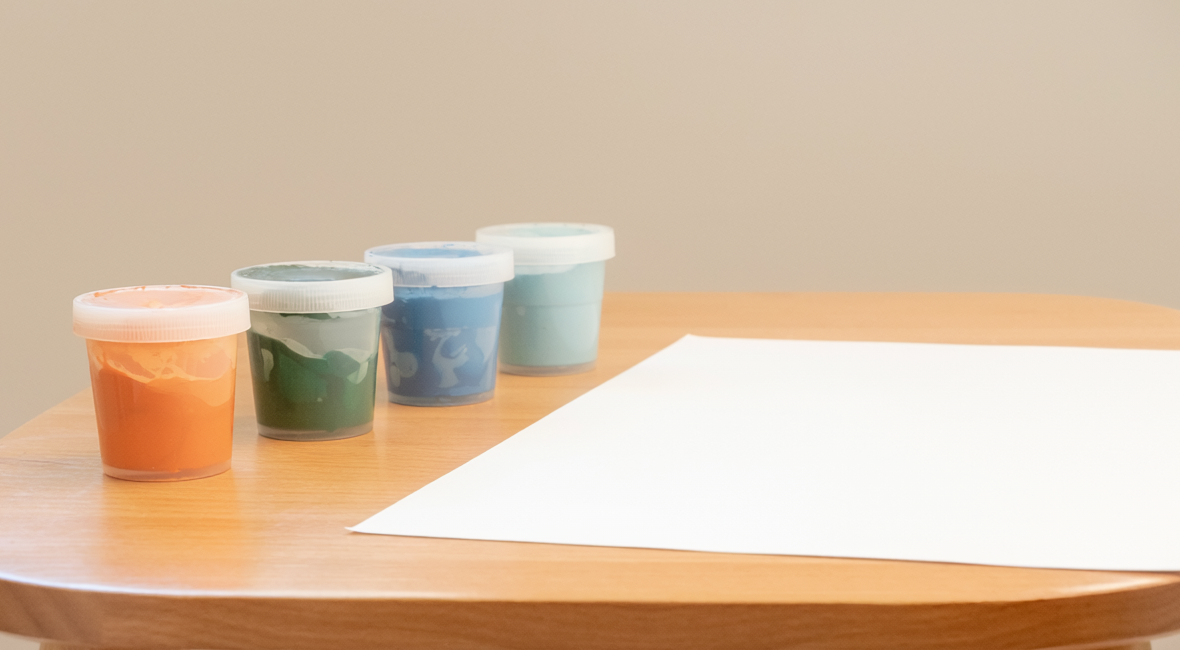 Illustrative photograph of paints and paper prepared for early-childhood art therapy