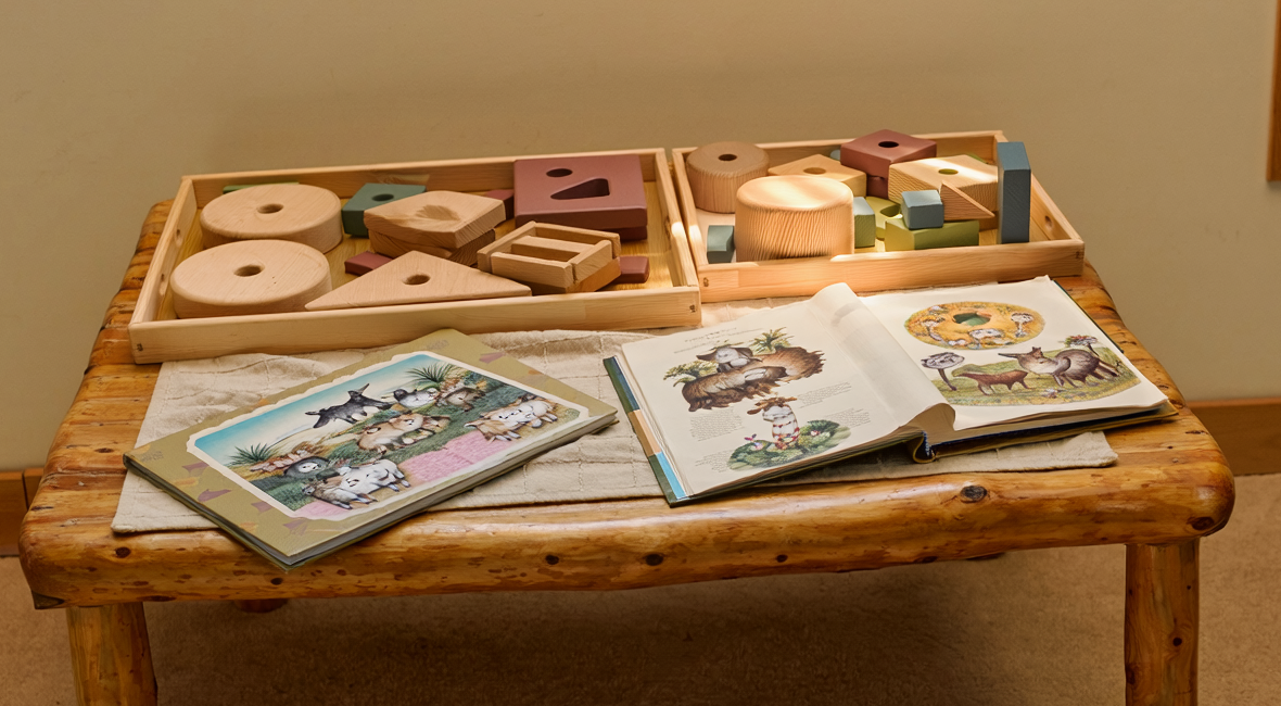 Illustrative photograph of an early-childhood learning table with shapes and picture books