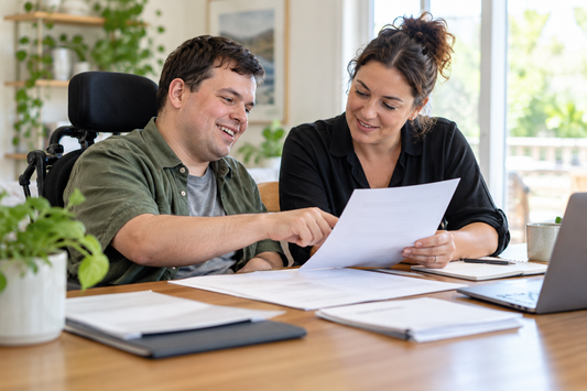 NDIS applicant and advocate reviewing application documents together