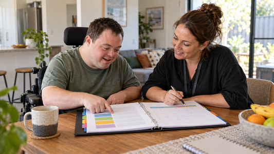 NDIS participant and support coordinator reviewing plan categories at home