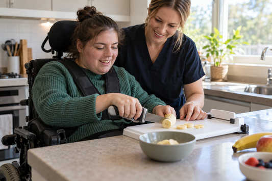 Occupational therapist supporting a person with disability to practise an everyday kitchen task