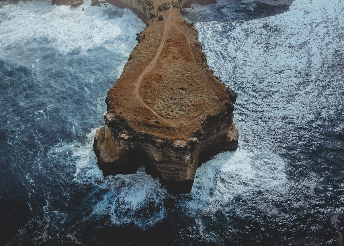 brown rocky mountain beside body of water
