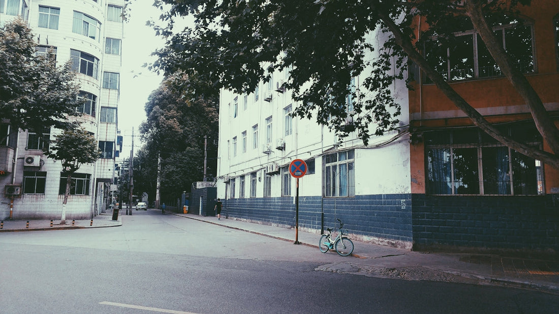 white concrete building near tree during daytime