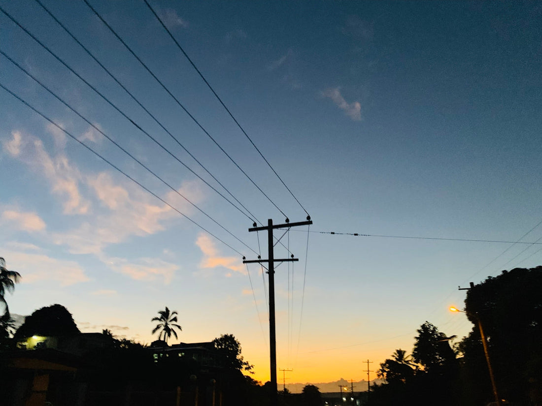 silhouette of electric post near trees during daytime