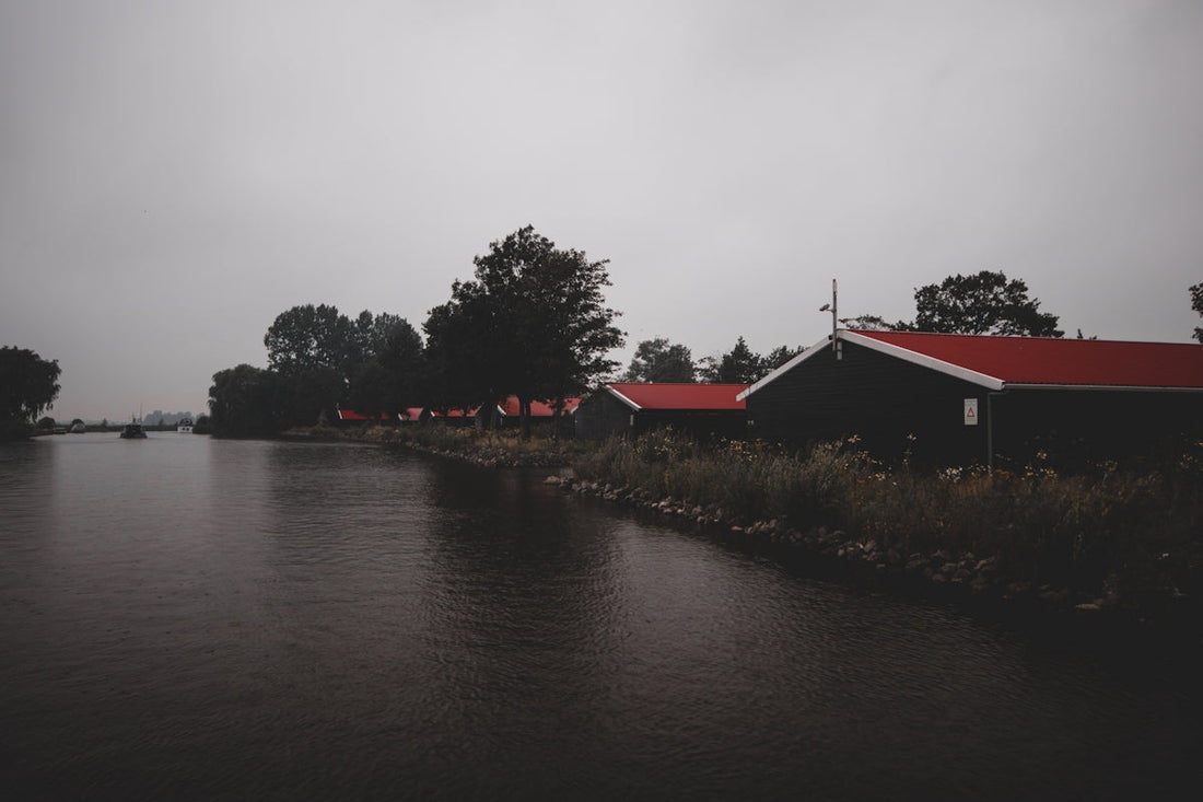 red roofed house by the river