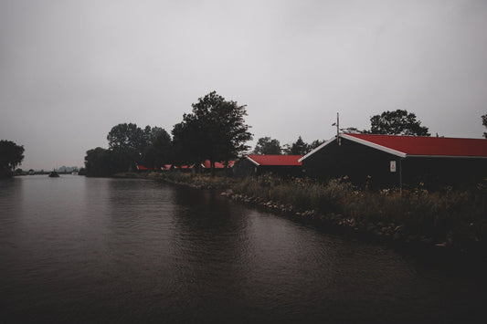 red roofed house by the river
