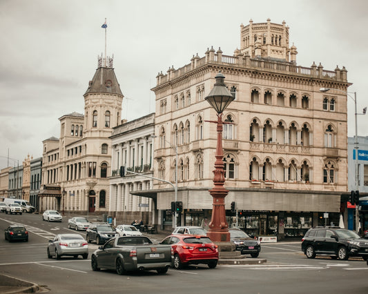 cars parked in front of beige concrete building during daytime
