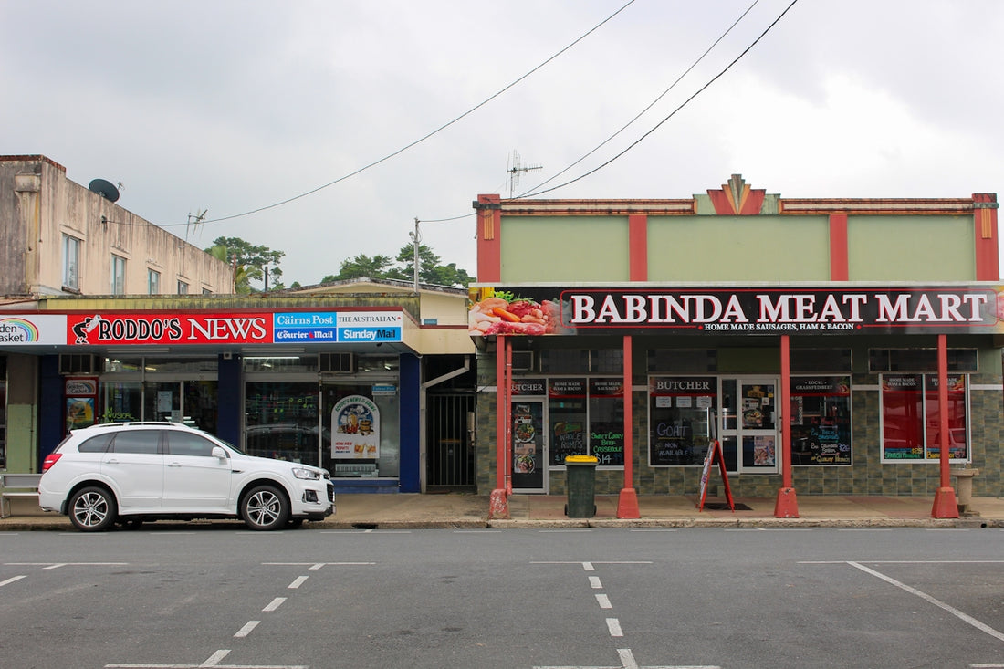 white sedan parked in front of UNKs restaurant