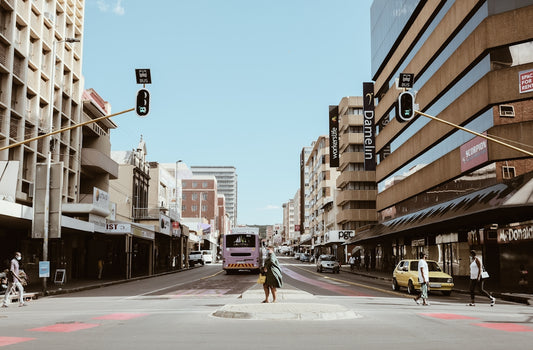 a person crossing a street in a city