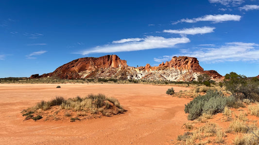 a desert landscape with a rocky mountain