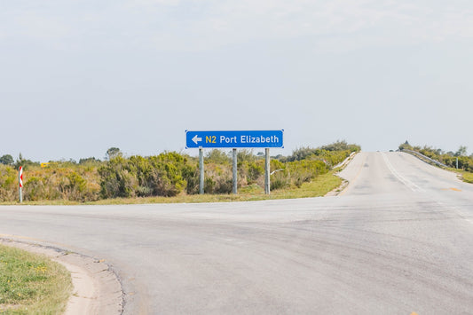 a blue sign on the side of a road
