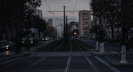 a city street with a train track running through it