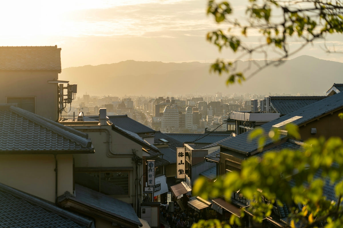 a view of a city with buildings and mountains in the background