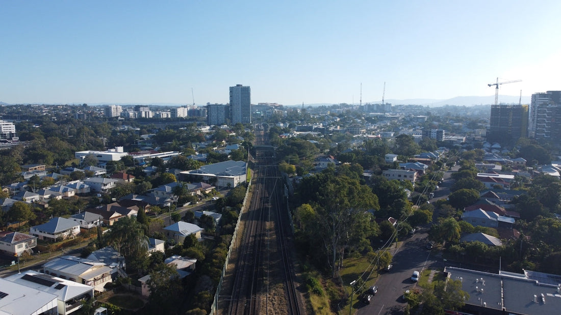 an aerial view of a city with a train on the tracks