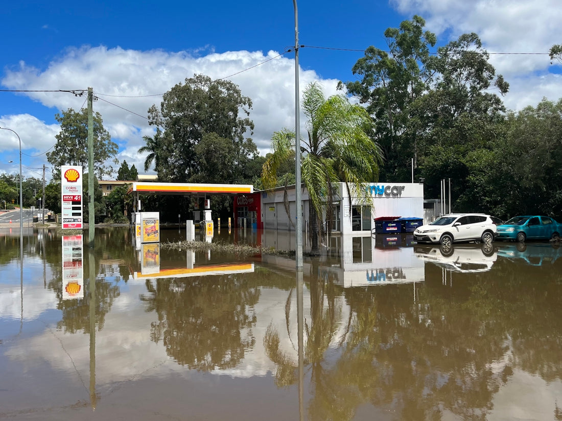 a flooded gas station with cars parked in it