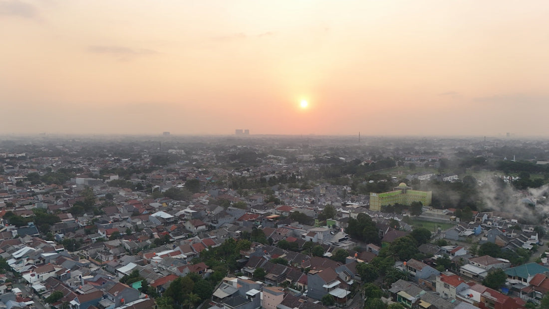 the sun is setting over a cityscape