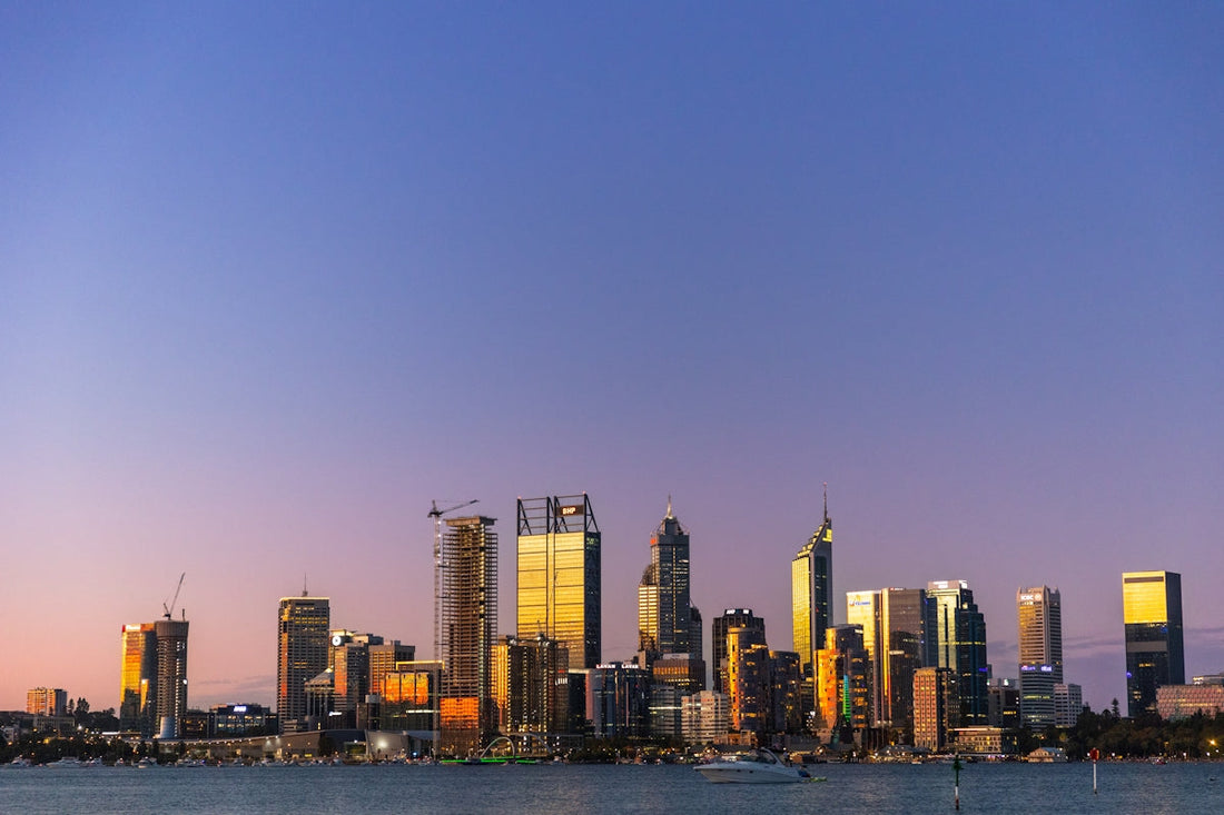 a view of a city at dusk from across the water