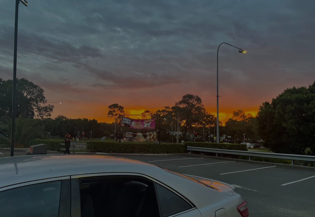 a car parked on the side of a road at sunset
