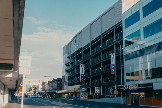 a city street lined with tall buildings on both sides of the street