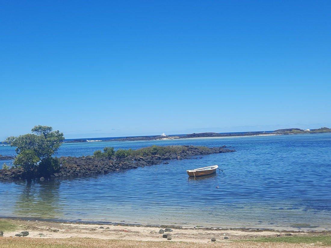 a small boat floating on top of a body of water