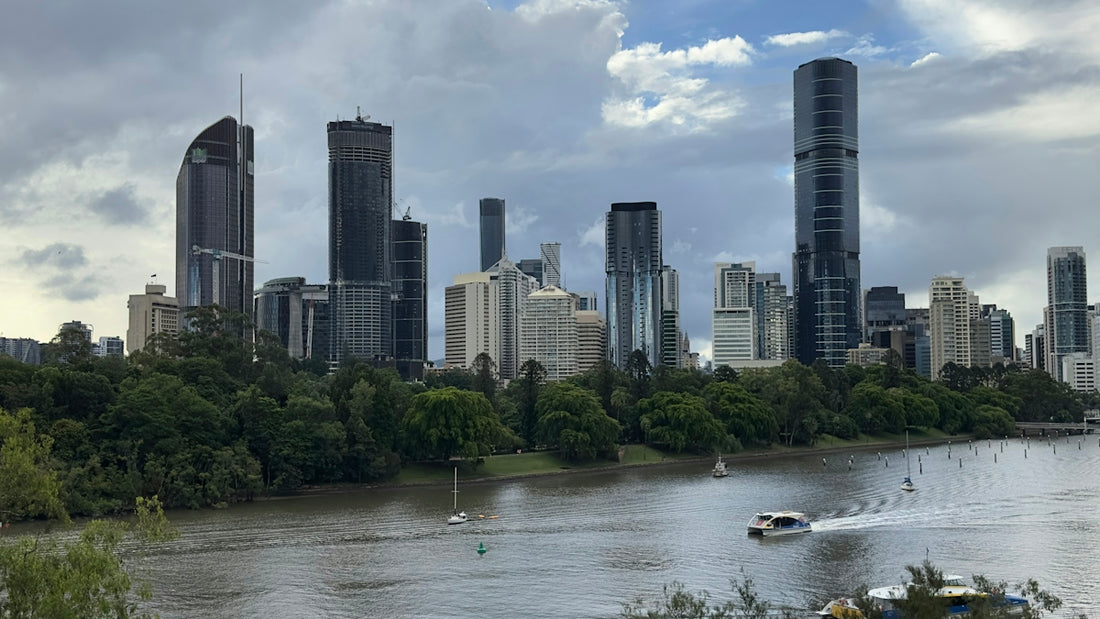 a river with a boat on it and a city in the background