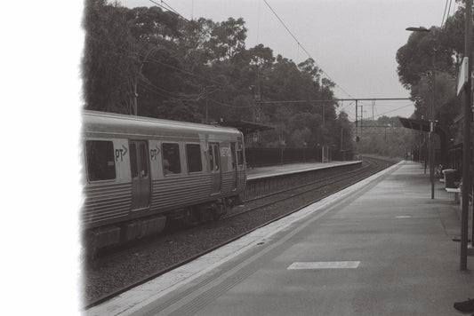 A black and white photo of a train on the tracks