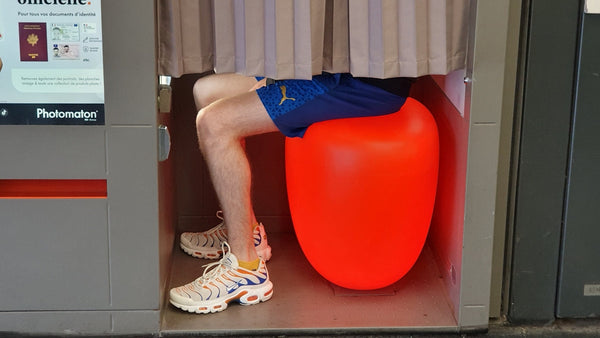 A person sitting on a large orange object
