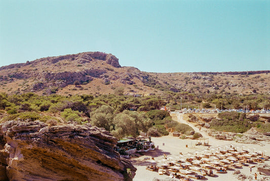A view of a beach with a mountain in the background