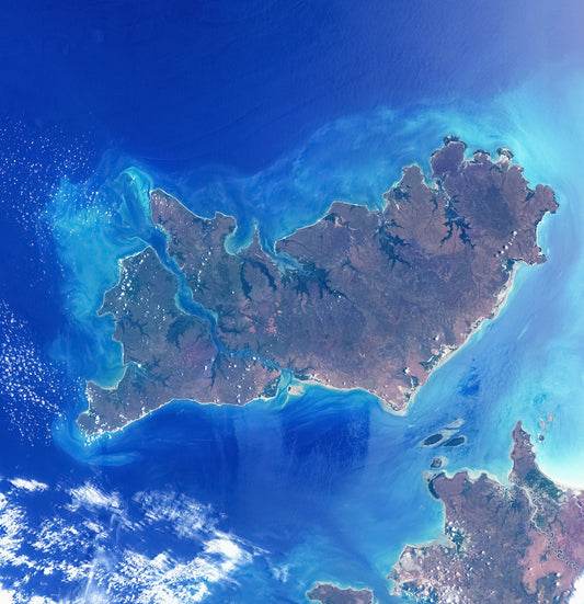 Aerial view of a large island surrounded by blue ocean.