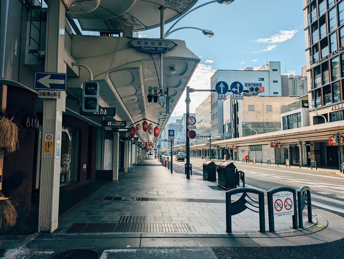 A city street with a train on the tracks
