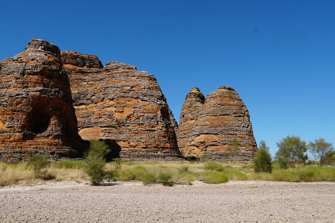 A large rock formation in the middle of a desert