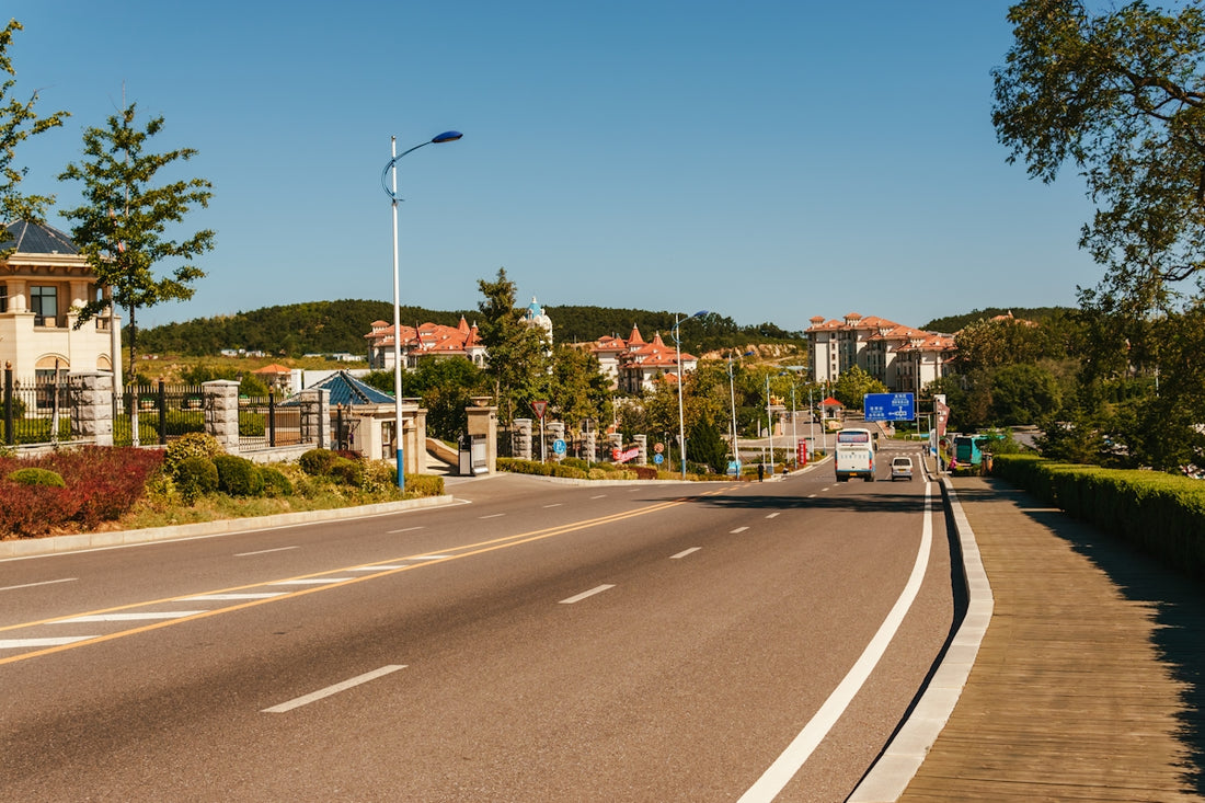 An empty street with houses in the background